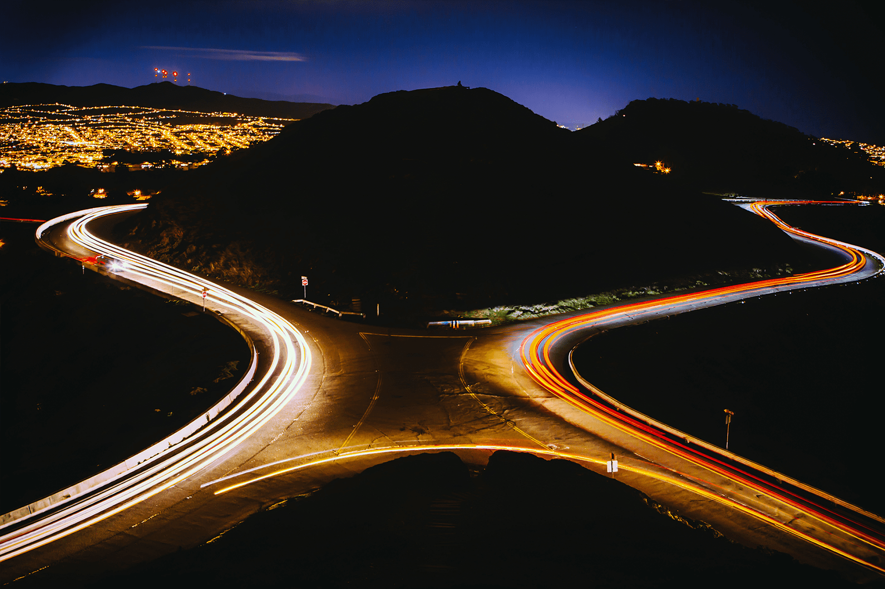 aerial view photography of crossroads near the mountain at night