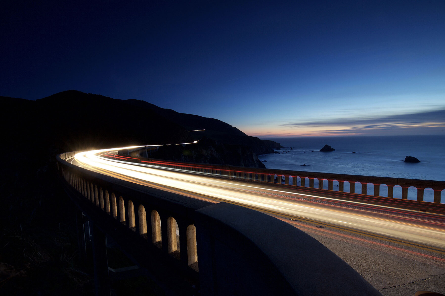 timelampse of car crossing bridge at sunset