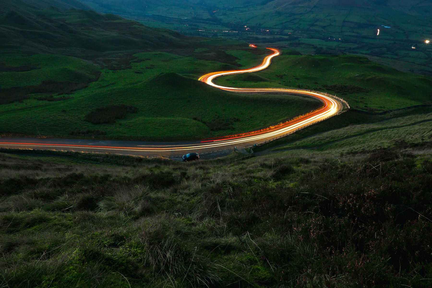 road winding through a countryside at night