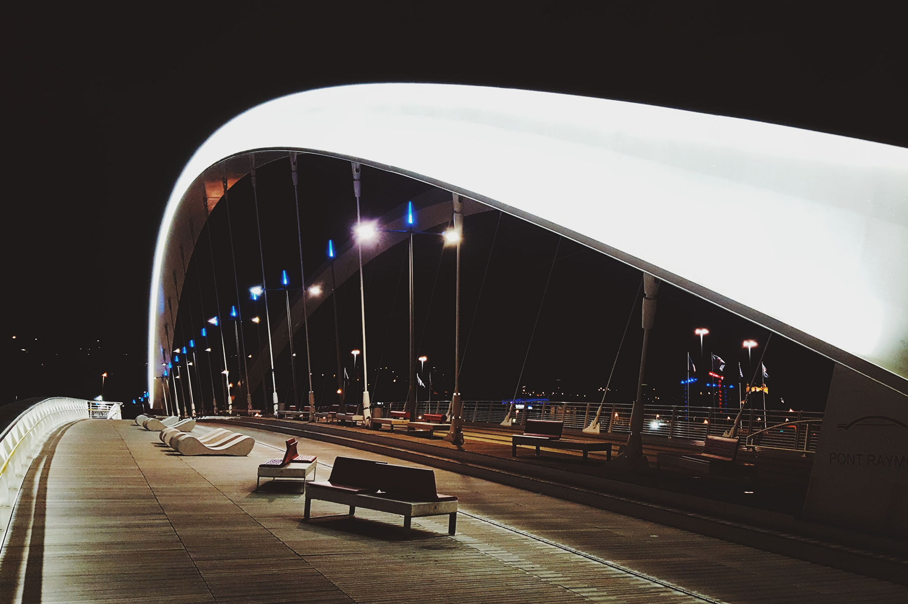 Suspension bridge at night over a platform